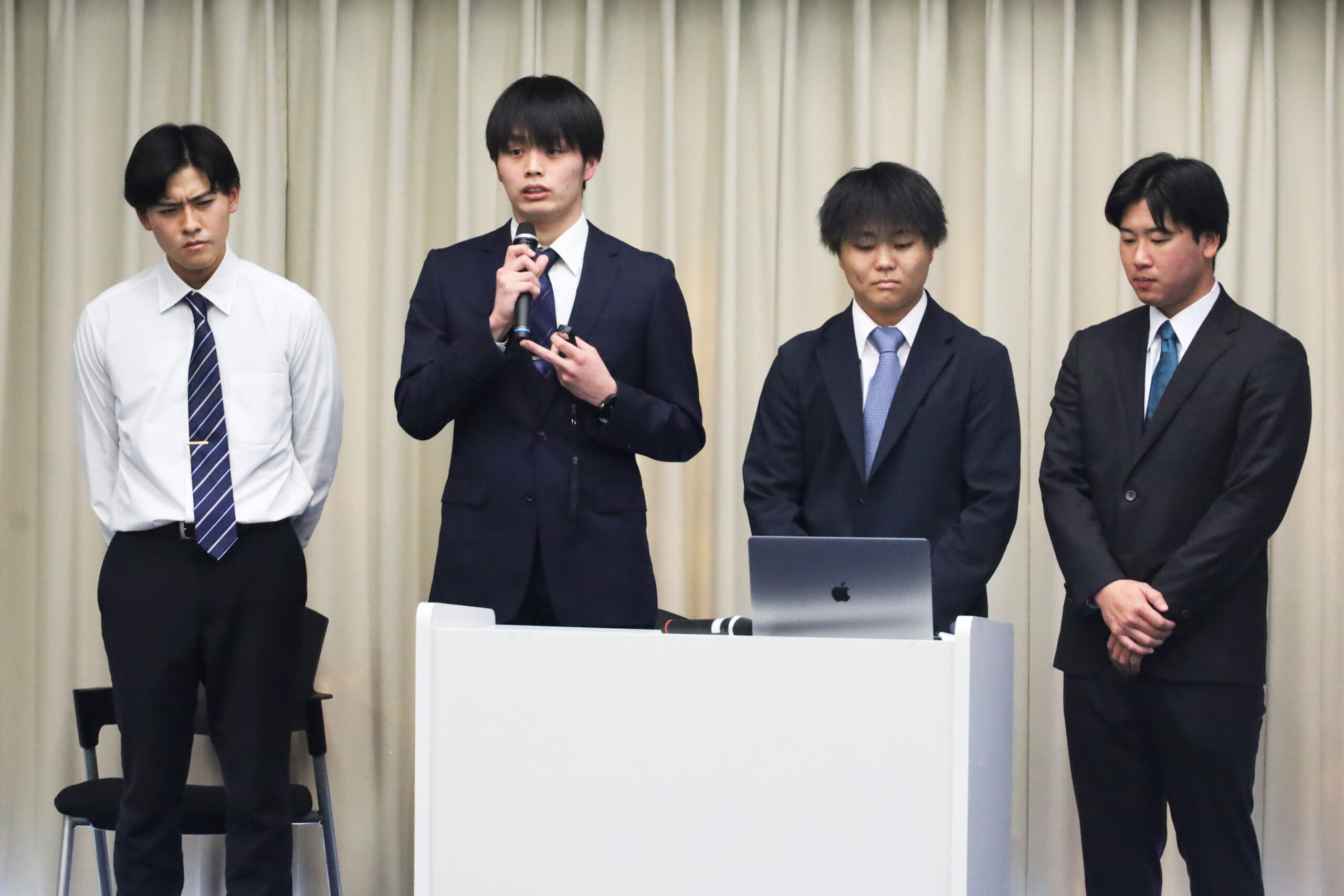 中学校での野球指導の活動を報告する山北佳輔さん（体育4年、大阪体育大学浪商）、瀬野川中学校での活動を報告する脇野嵩大さん（体育4年、須磨学園）、岡村和紀さん（体育4年、府中）、藤原光一朗さん（体育4年、安芸府中）